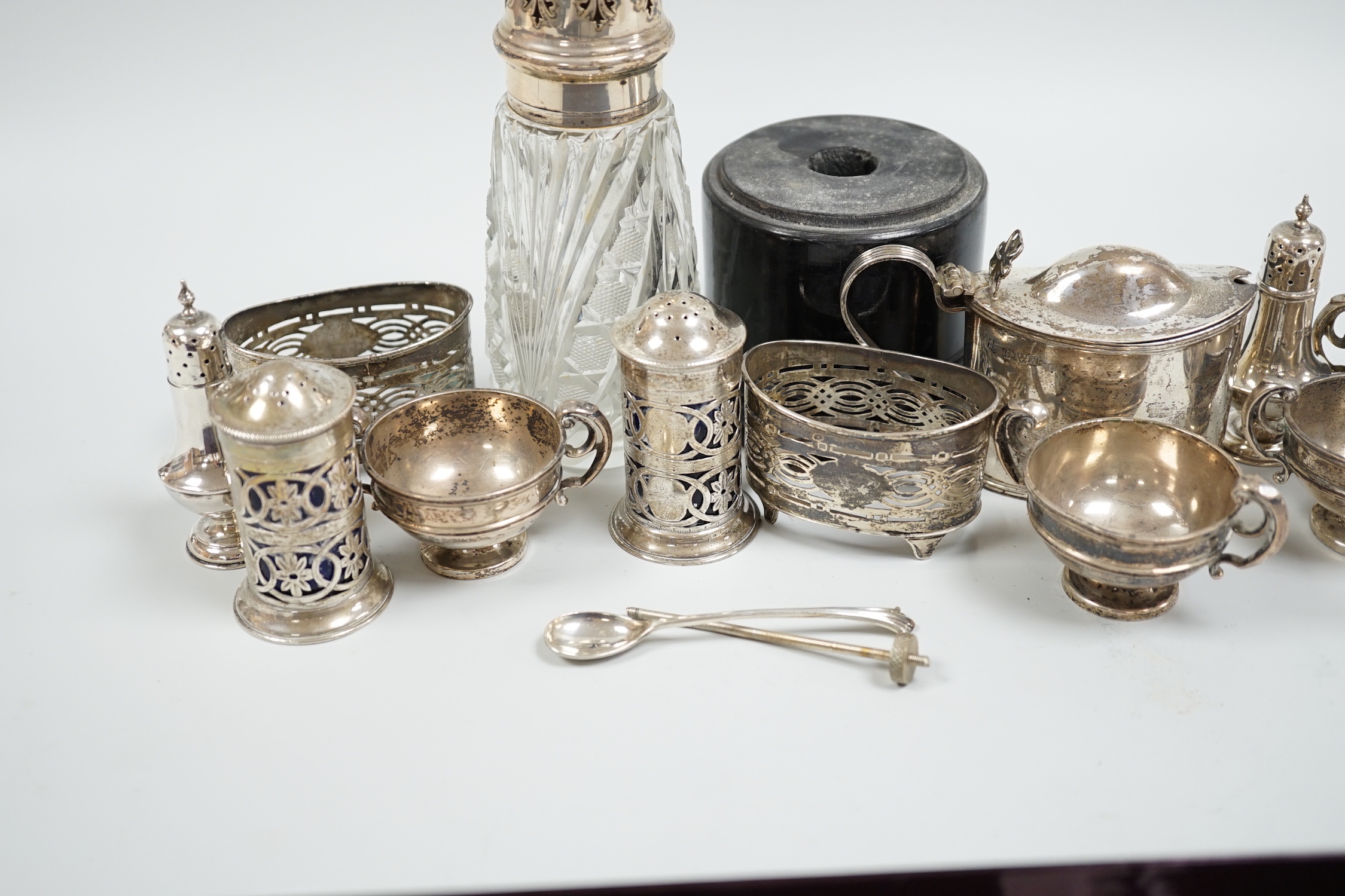 Sundry silver items including mainly condiments and a silver mounted glass caster.